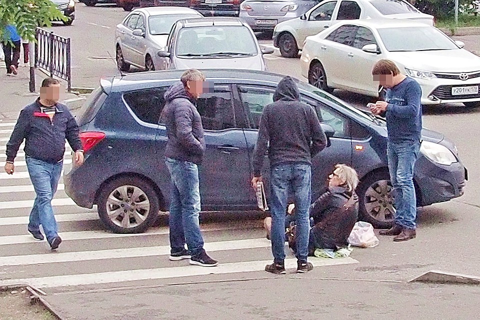 В центре Мурманска сбили человека. Мужчина с белой шевелюрой сидел на асфальте, обхватив поврежденную ногу, и дожидался прибытия медиков.